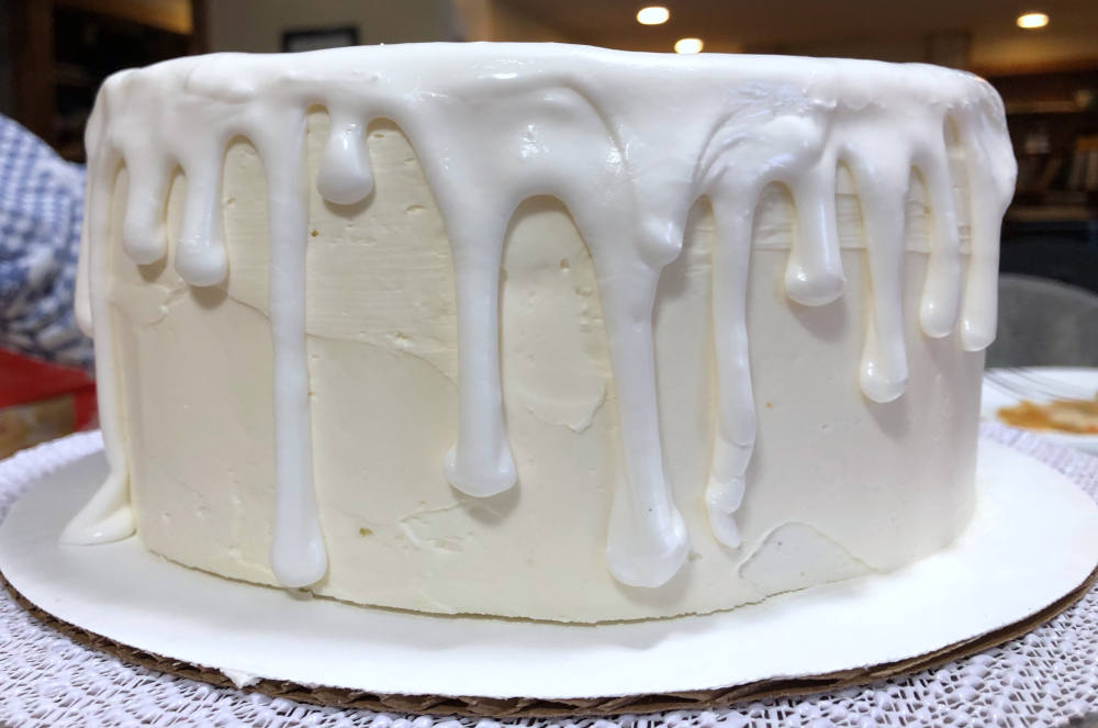 Imperfect royal icing drips on the cake