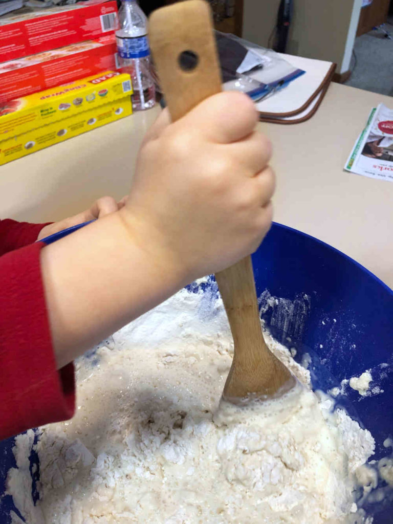 child mixing irish soda bread