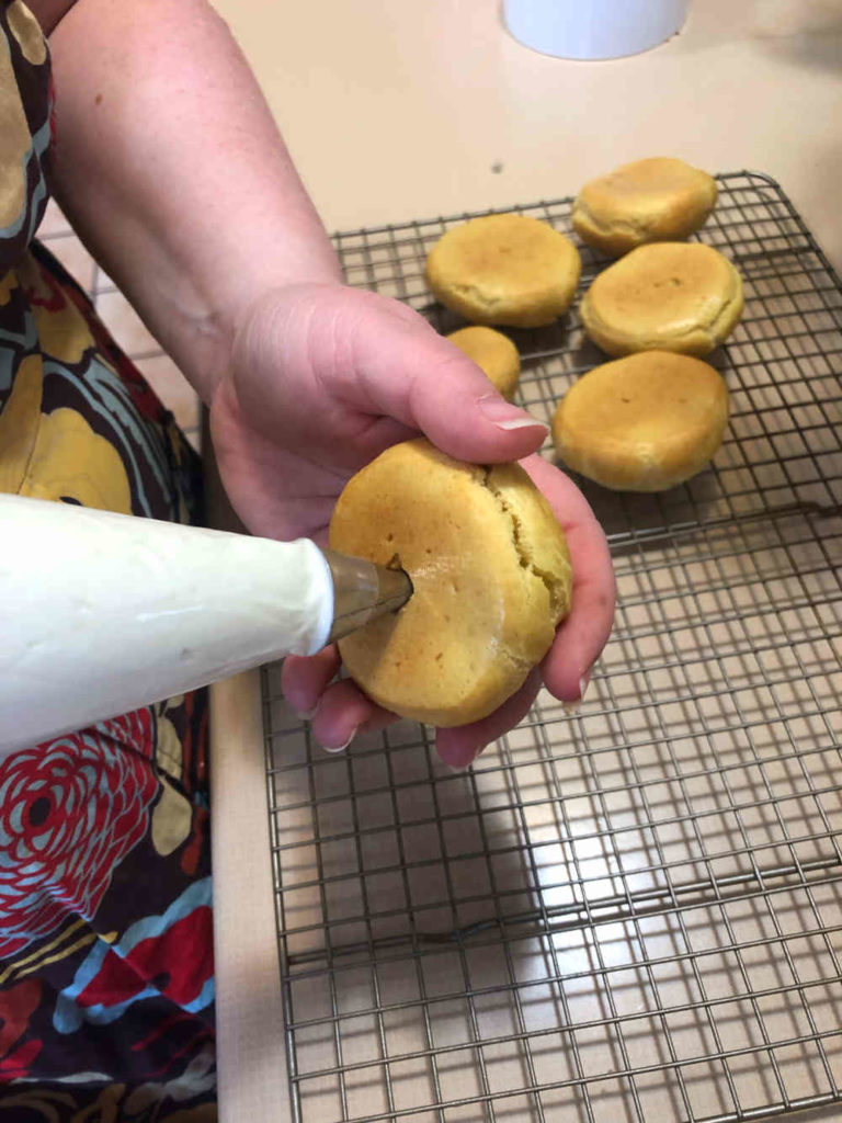 putting cream in cream puff