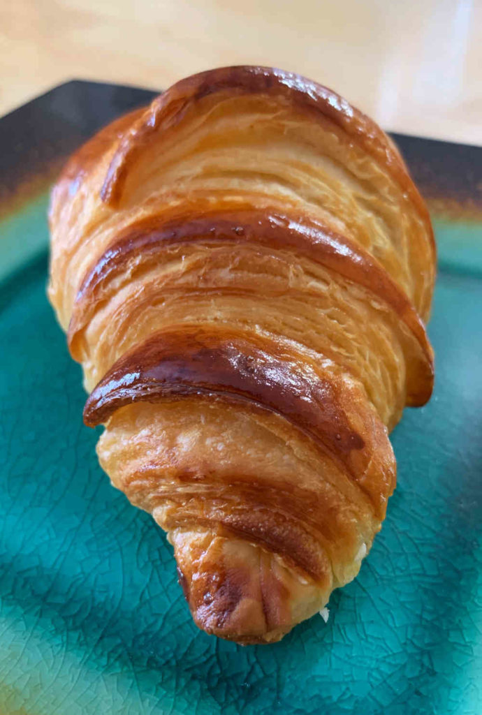 detailed photo of side of baked croissant